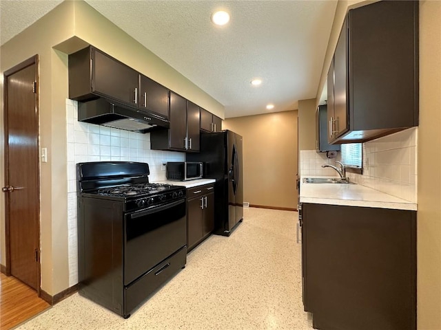 1125 W 10th Ave, Marion, IA 52302 - kitchen with black appliances, under cabinet range hood, light countertops, tasteful backsplash, and recessed lighting