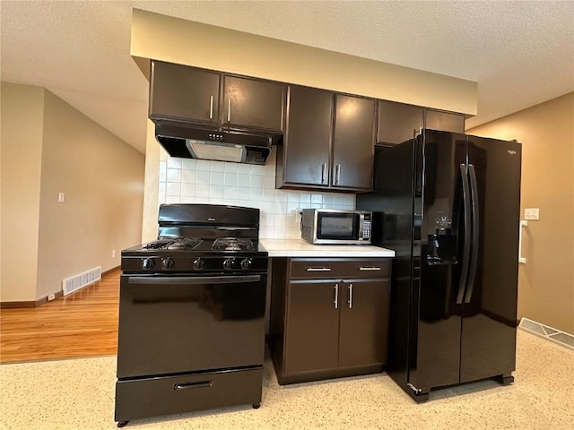 1125 W 10th Ave, Marion, IA 52302 - kitchen featuring black appliances, exhaust hood, decorative backsplash, light countertops, and a textured ceiling