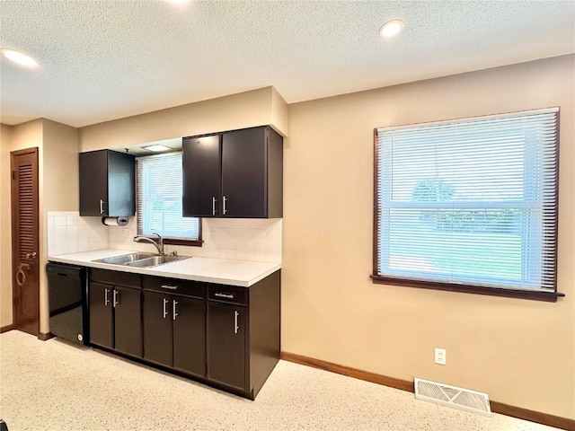 1125 W 10th Ave, Marion, IA 52302 - kitchen with dishwasher, backsplash, light countertops, a textured ceiling, and recessed lighting