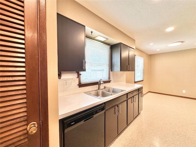 1125 W 10th Ave, Marion, IA 52302 - kitchen featuring dishwashing machine, light countertops, a textured ceiling, backsplash, and dark speckled floor