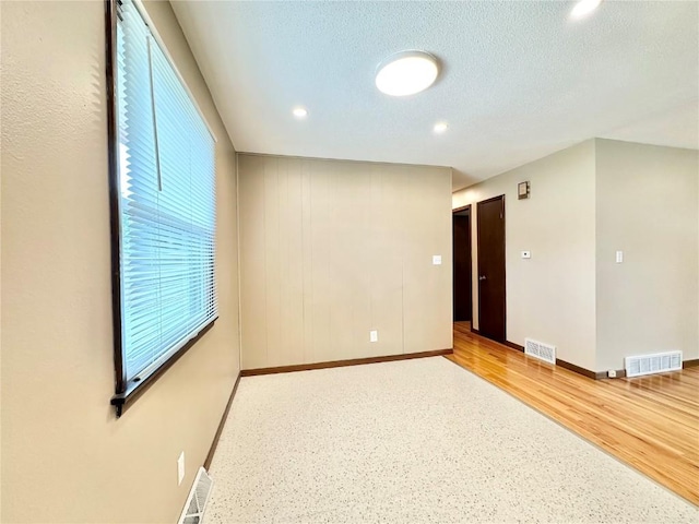 1125 W 10th Ave, Marion, IA 52302 - spare room with recessed lighting, wood finished floors, and a textured ceiling