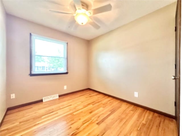 1125 W 10th Ave, Marion, IA 52302 - spare room with ceiling fan and light wood-style floors