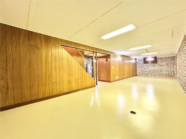 1125 W 10th Ave, Marion, IA 52302 - finished basement featuring a drop ceiling, wooden walls, and stairs