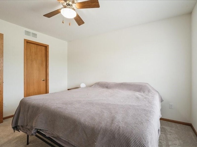 935 74th St NE Unit 5, Cedar Rapids, IA 52402 - bedroom with light colored carpet and a ceiling fan