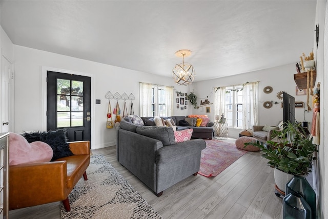 2518 1st Ave NE, Cedar Rapids, IA 52402 - living area with light wood finished floors and a chandelier