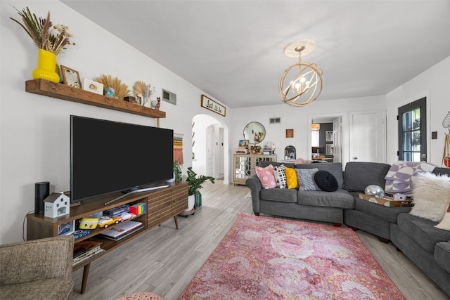 2518 1st Ave NE, Cedar Rapids, IA 52402 - living room with arched walkways, a chandelier, and wood finished floors