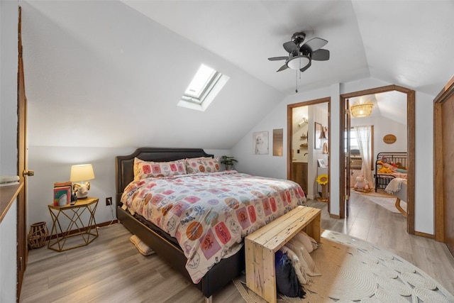 2518 1st Ave NE, Cedar Rapids, IA 52402 - bedroom with light wood-style floors, lofted ceiling, a skylight, and ceiling fan