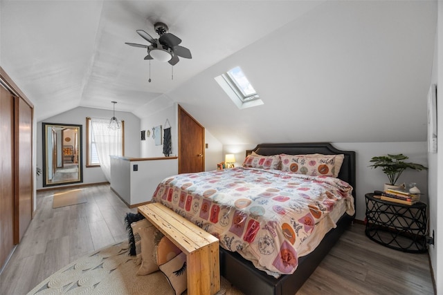 2518 1st Ave NE, Cedar Rapids, IA 52402 - bedroom featuring vaulted ceiling, a skylight, wood finished floors, and a ceiling fan