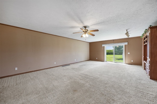 204 Northgate St, Shellsburg, IA 52332 - spare room with a ceiling fan, light colored carpet, a textured ceiling, and crown molding