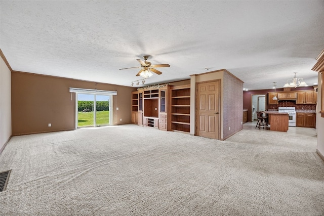 204 Northgate St, Shellsburg, IA 52332 - unfurnished living room featuring a ceiling fan, a textured ceiling, light colored carpet, and a chandelier