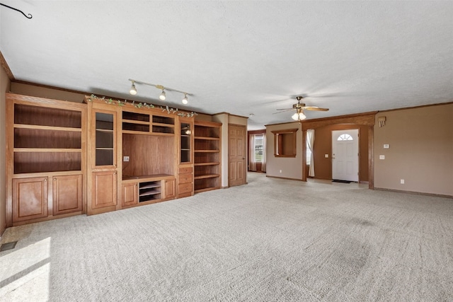204 Northgate St, Shellsburg, IA 52332 - unfurnished living room with light carpet, a ceiling fan, and crown molding
