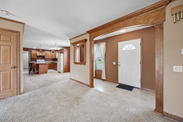 204 Northgate St, Shellsburg, IA 52332 - entryway featuring a chandelier, light carpet, and crown molding
