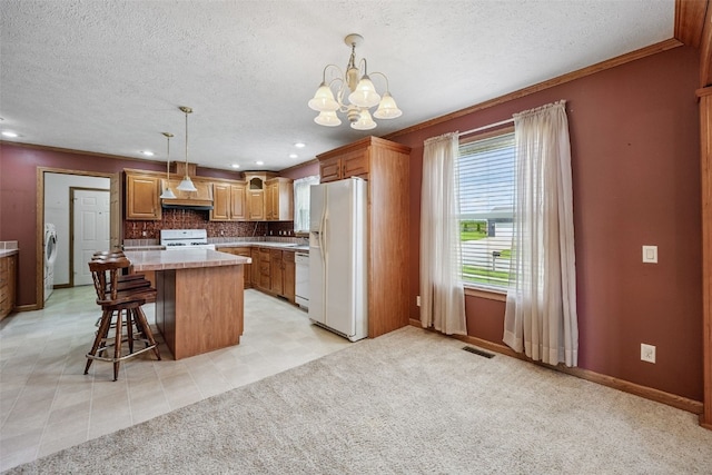 204 Northgate St, Shellsburg, IA 52332 - kitchen with white appliances, washer / dryer, a chandelier, a textured ceiling, and light countertops