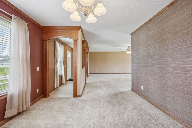 204 Northgate St, Shellsburg, IA 52332 - spare room featuring light carpet, a chandelier, a ceiling fan, arched walkways, and a textured ceiling