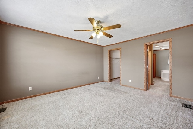 204 Northgate St, Shellsburg, IA 52332 - unfurnished bedroom featuring light colored carpet, ceiling fan, a spacious closet, and ornamental molding