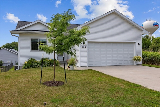 904 Hughes St, Coralville, IA 52241 - ranch-style home with a front yard, concrete driveway, and a garage