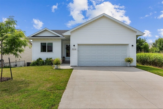 904 Hughes St, Coralville, IA 52241 - ranch-style home with a front lawn, driveway, and an attached garage