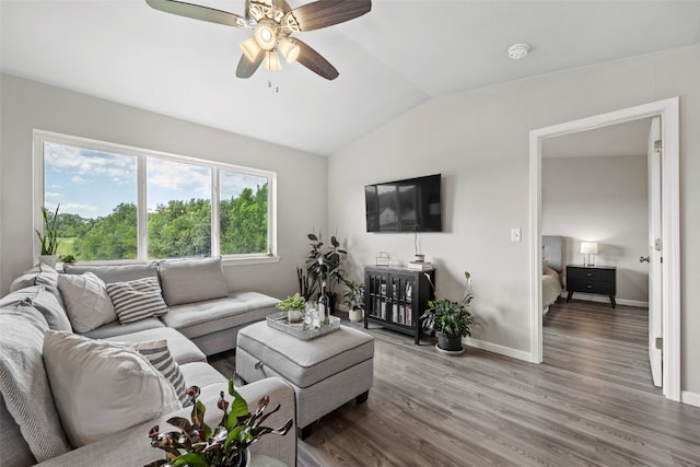 904 Hughes St, Coralville, IA 52241 - living area with vaulted ceiling, wood finished floors, and a ceiling fan