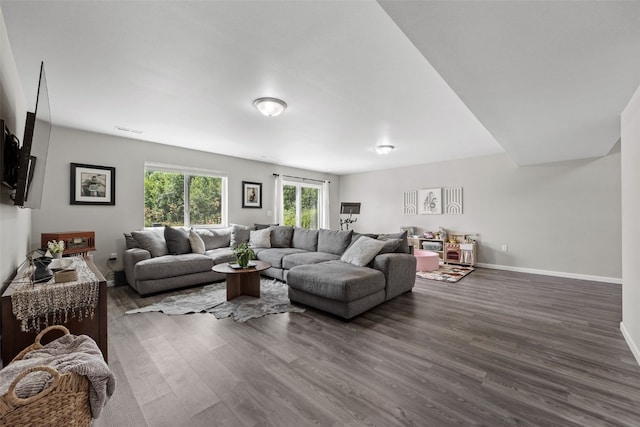 904 Hughes St, Coralville, IA 52241 - living area featuring dark wood-type flooring and baseboards