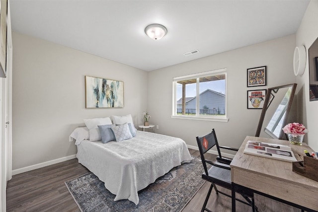 904 Hughes St, Coralville, IA 52241 - bedroom with dark wood-type flooring and baseboards
