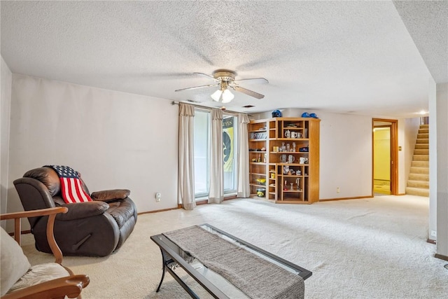 918 29th St NW, Cedar Rapids, IA 52405 - living area featuring ceiling fan, carpet flooring, stairs, and a textured ceiling