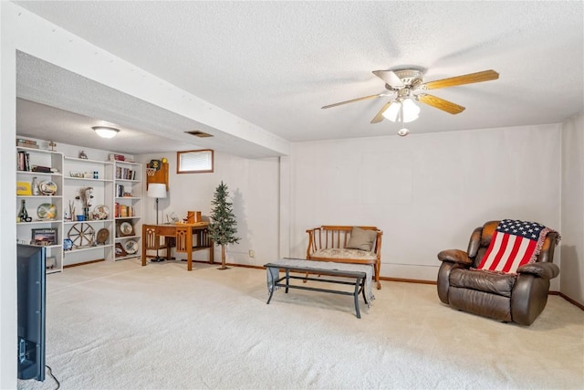 918 29th St NW, Cedar Rapids, IA 52405 - living area with carpet, a textured ceiling, and a ceiling fan