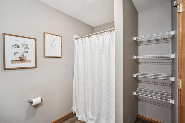 780 Magnolia Ln Unit 4, Marion, IA 52302 - bathroom with a shower with curtain and wood finished floors