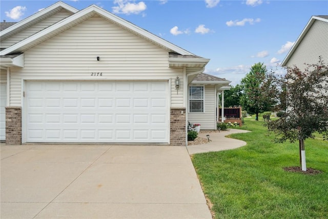 2176 49th St, Marion, IA 52302 - view of front of house with an attached garage, driveway, a front yard, and brick siding