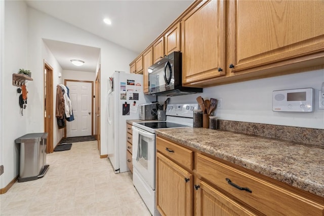 2176 49th St, Marion, IA 52302 - kitchen with white appliances, lofted ceiling, and recessed lighting
