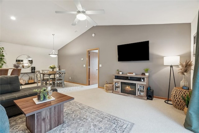 2176 49th St, Marion, IA 52302 - carpeted living area featuring vaulted ceiling, a ceiling fan, and a glass covered fireplace