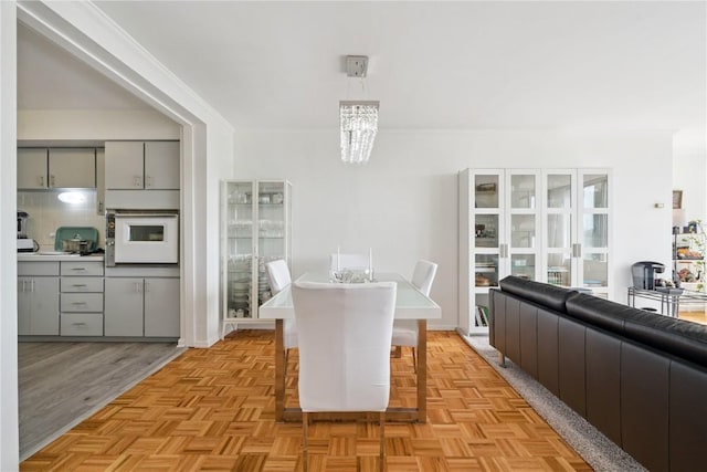 2222 1st Ave, Cedar Rapids, IA 52402 - dining room featuring a chandelier and ornamental molding
