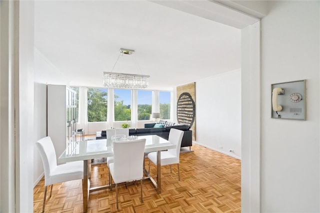 2222 1st Ave, Cedar Rapids, IA 52402 - dining room featuring baseboards and a chandelier