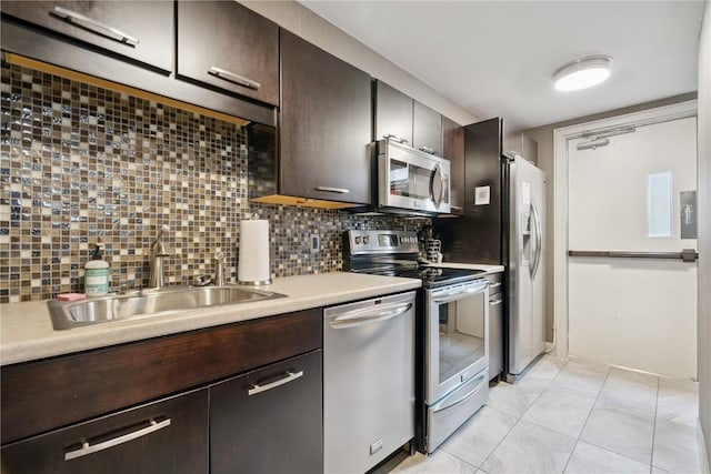 2222 1st Ave, Cedar Rapids, IA 52402 - kitchen featuring stainless steel appliances, dark brown cabinetry, backsplash, and light countertops