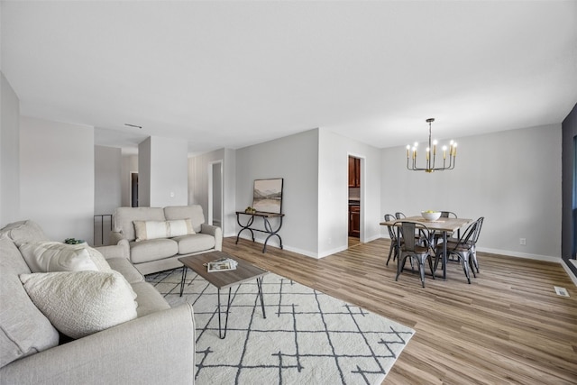 4812 Montclair Dr NW, Cedar Rapids, IA 52405 - living area with a chandelier and light wood-style flooring