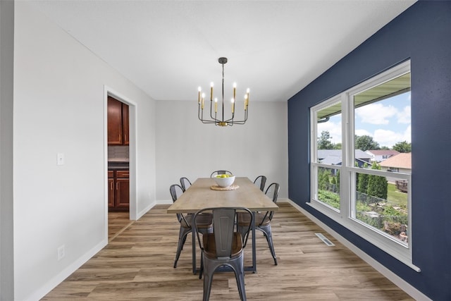 4812 Montclair Dr NW, Cedar Rapids, IA 52405 - dining area with a chandelier and light wood-style floors
