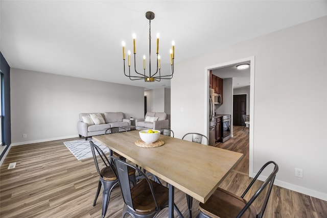 4812 Montclair Dr NW, Cedar Rapids, IA 52405 - dining room with wood finished floors and a chandelier