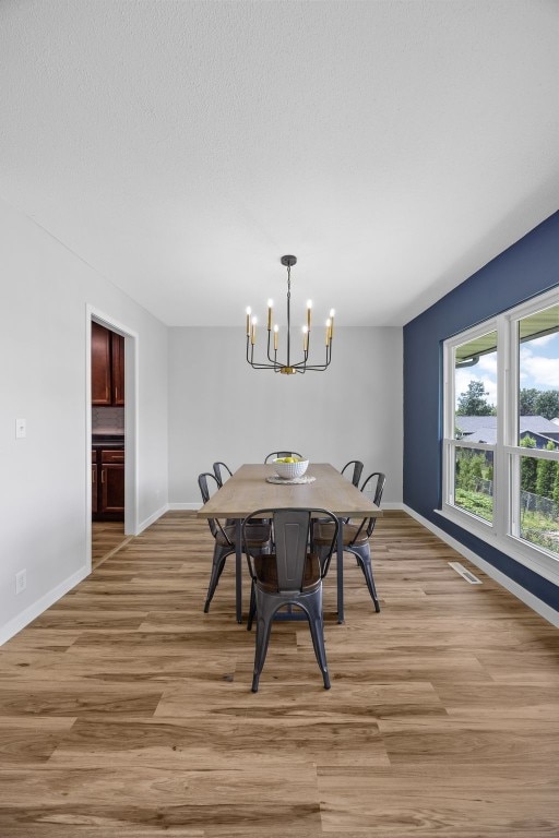 4812 Montclair Dr NW, Cedar Rapids, IA 52405 - dining space featuring a chandelier and light wood finished floors
