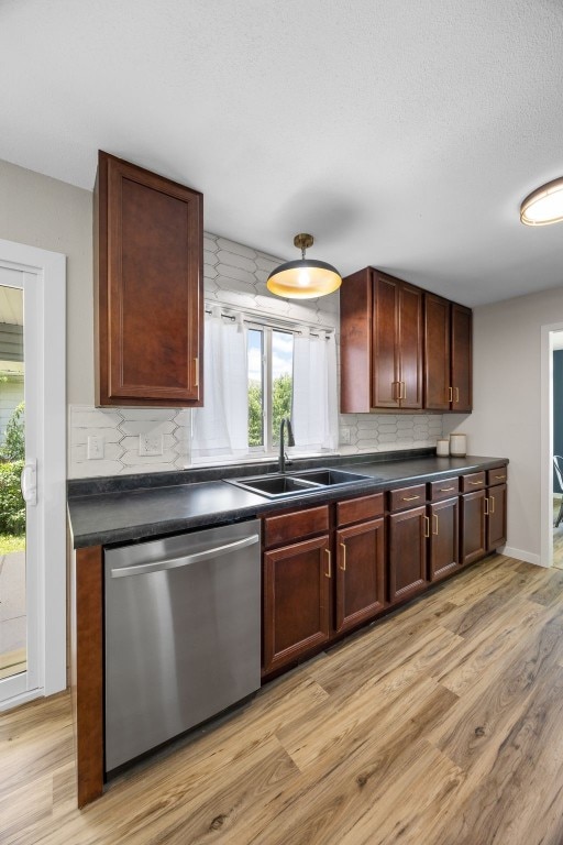 4812 Montclair Dr NW, Cedar Rapids, IA 52405 - kitchen featuring dishwasher, dark countertops, and light wood-style flooring