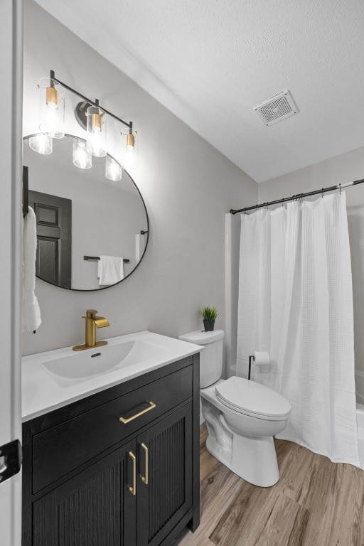 4812 Montclair Dr NW, Cedar Rapids, IA 52405 - bathroom featuring vanity, wood finished floors, and a textured ceiling