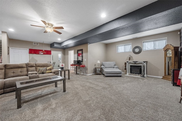 2816 Fruitland Blvd SW, Cedar Rapids, IA 52404 - living room featuring ceiling fan, carpet flooring, a textured ceiling, a fireplace, and recessed lighting