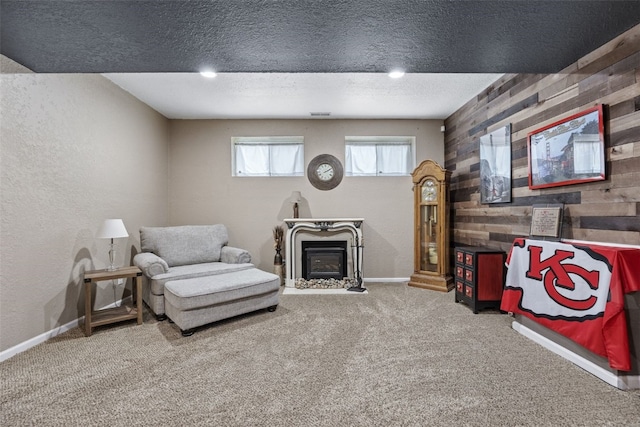 2816 Fruitland Blvd SW, Cedar Rapids, IA 52404 - sitting room featuring carpet, wooden walls, a textured wall, a textured ceiling, and a fireplace