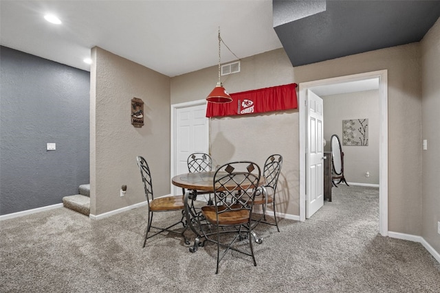 2816 Fruitland Blvd SW, Cedar Rapids, IA 52404 - dining room featuring carpet flooring, stairs, and a textured wall
