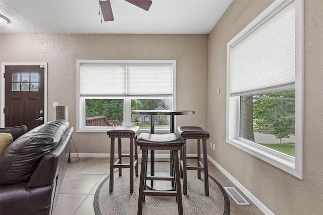 2816 Fruitland Blvd SW, Cedar Rapids, IA 52404 - dining room with a textured wall, a ceiling fan, and light tile patterned floors