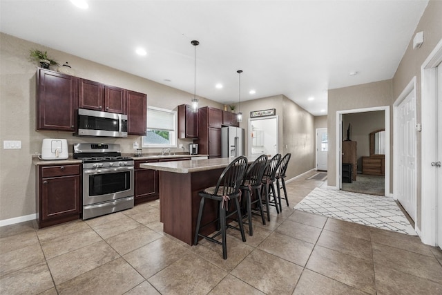 2816 Fruitland Blvd SW, Cedar Rapids, IA 52404 - kitchen with appliances with stainless steel finishes, a breakfast bar area, a kitchen island, recessed lighting, and pendant lighting