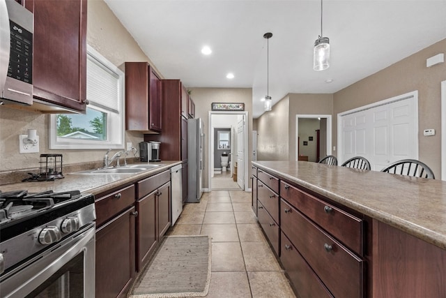 2816 Fruitland Blvd SW, Cedar Rapids, IA 52404 - kitchen featuring appliances with stainless steel finishes, hanging light fixtures, light tile patterned flooring, a kitchen breakfast bar, and recessed lighting