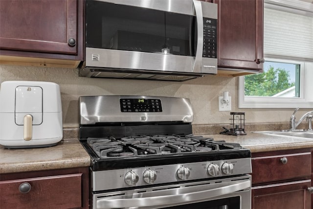 2816 Fruitland Blvd SW, Cedar Rapids, IA 52404 - kitchen with appliances with stainless steel finishes, light countertops, backsplash, and dark brown cabinets