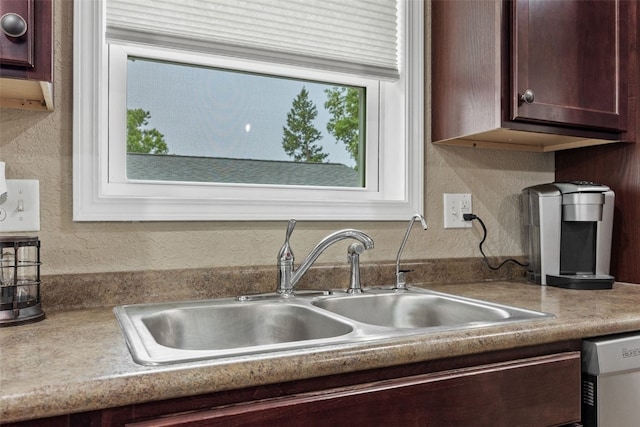 2816 Fruitland Blvd SW, Cedar Rapids, IA 52404 - kitchen featuring dishwashing machine, dark brown cabinetry, a textured wall, and light countertops