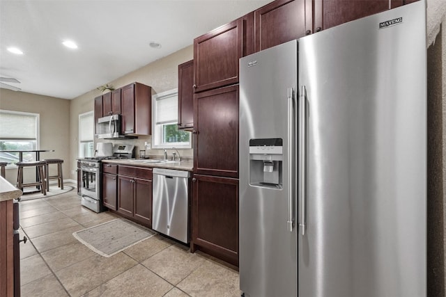 2816 Fruitland Blvd SW, Cedar Rapids, IA 52404 - kitchen featuring stainless steel appliances, light countertops, light tile patterned floors, recessed lighting, and ceiling fan