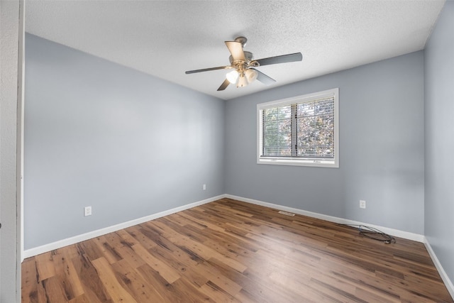 1125 Saint Andrews Dr, North Liberty, IA 52317 - spare room with wood finished floors, ceiling fan, and a textured ceiling