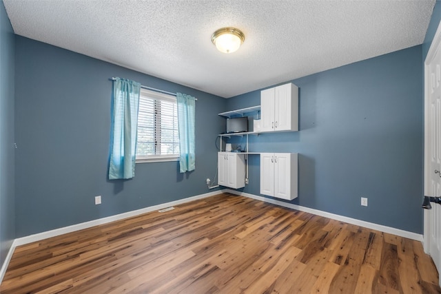 1125 Saint Andrews Dr, North Liberty, IA 52317 - kitchen with dark wood-style floors, white cabinets, a textured ceiling, and open shelves
